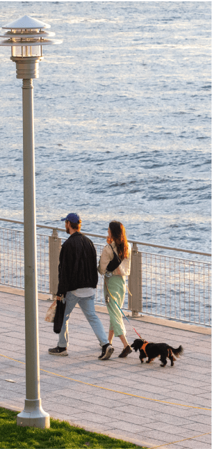 Couple walking dog - waterfront green spaces in Williamsburg, Brooklyn