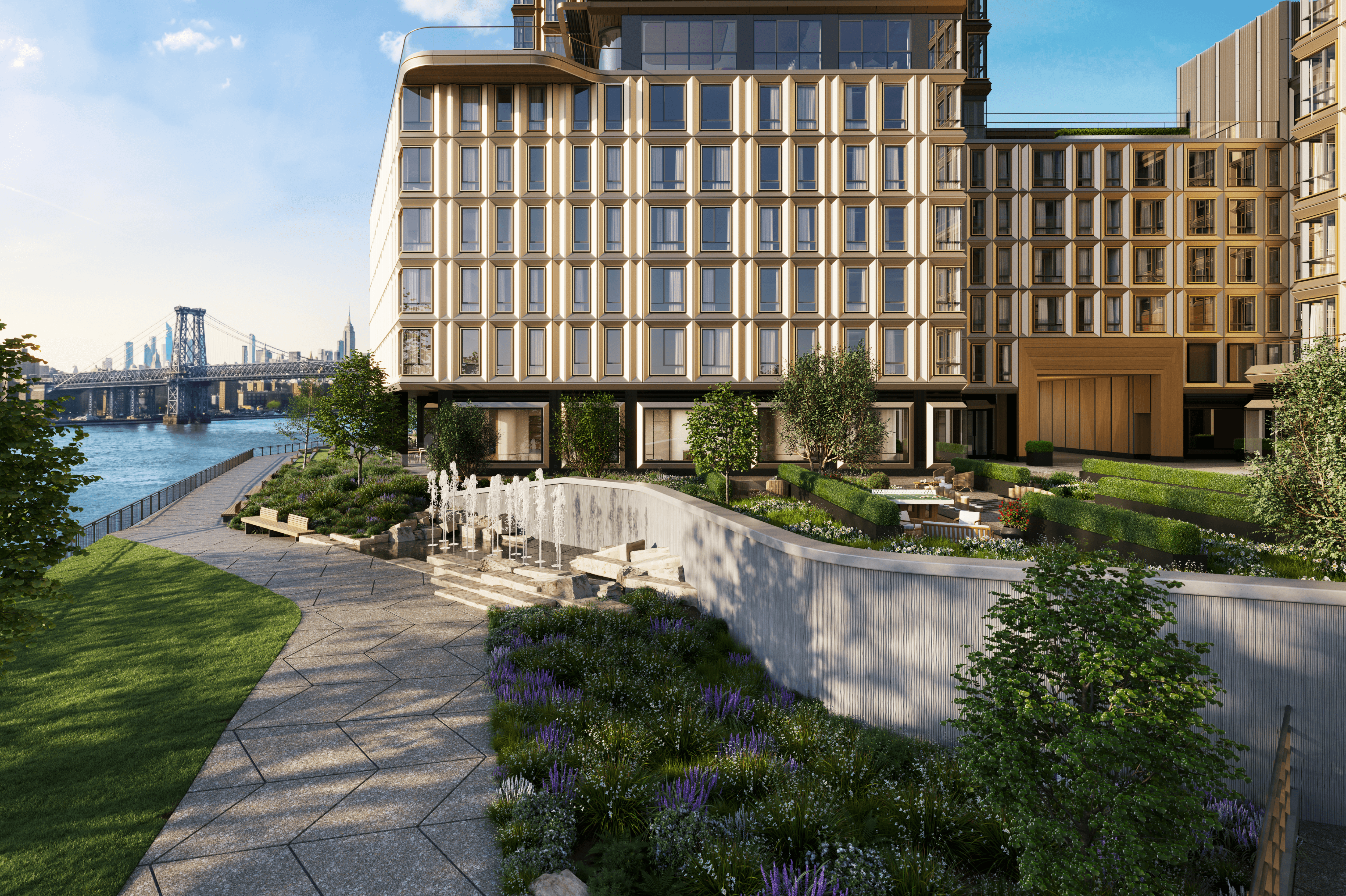 Waterfront esplanade at Williamsburg Wharf with walking path, water feature, seating, and views of the East River.