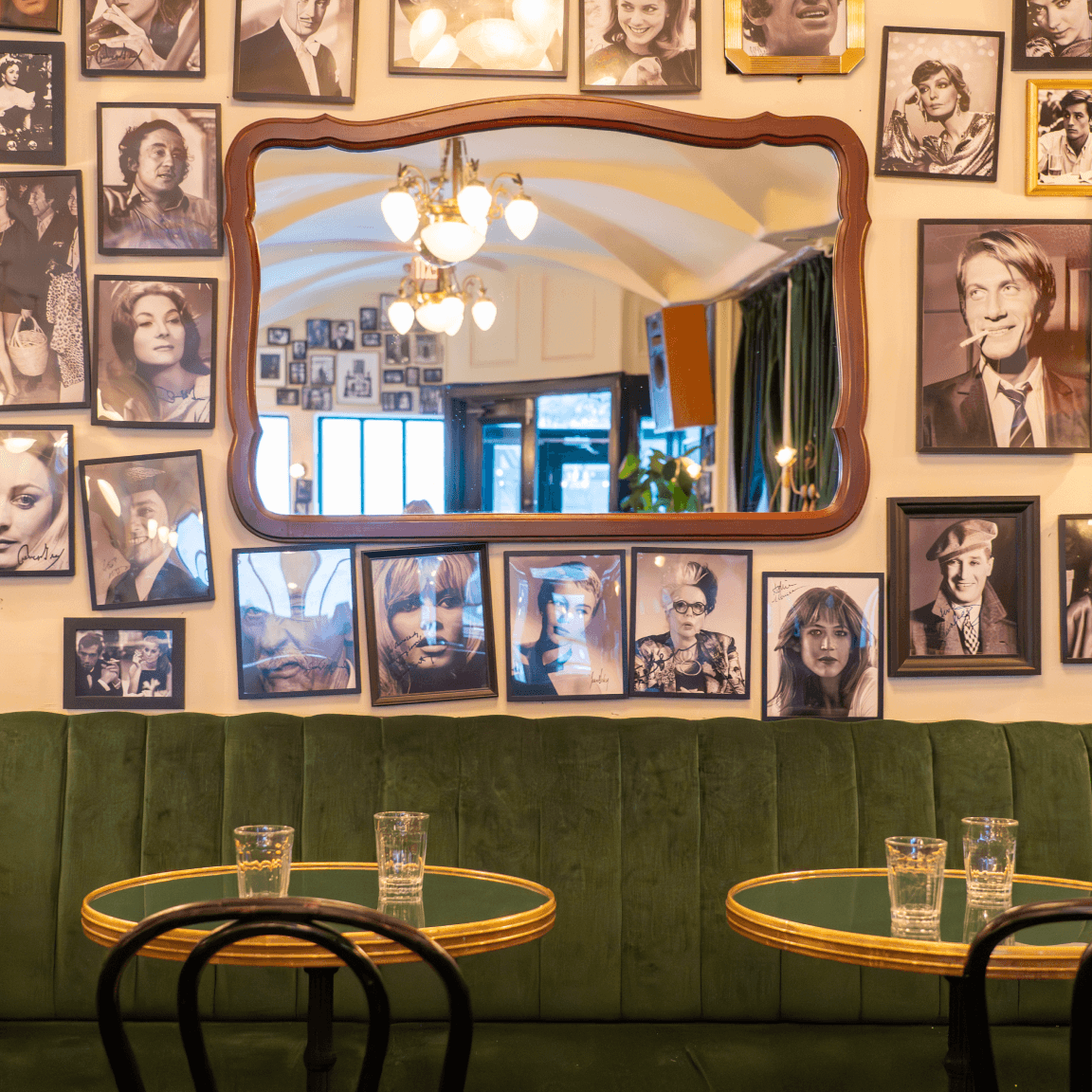 Black and white photographs on a wall surrounding a large mirror in Williamsburg, Brooklyn