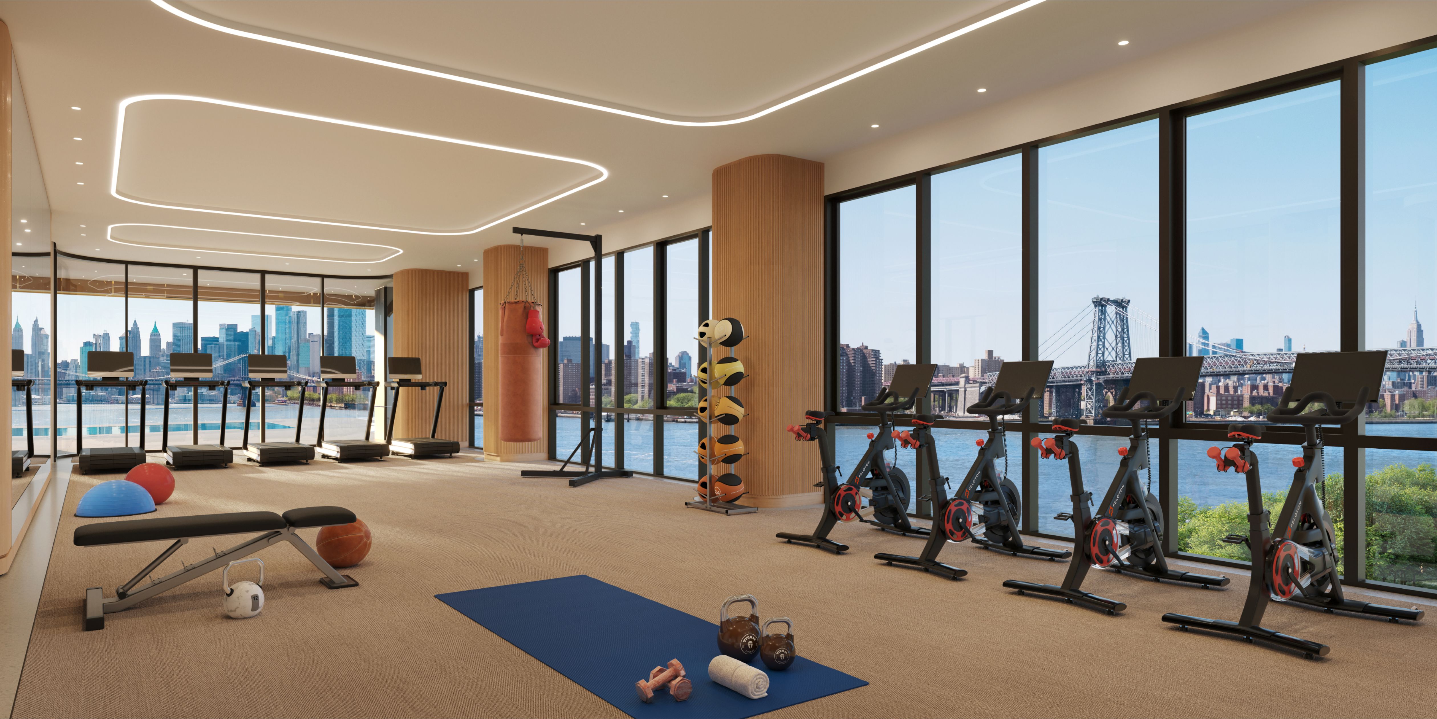 Indoor-outdoor fitness center at the Williamsburg Wharf Resort & Recreation Club with cardio equipment and strength training machines.