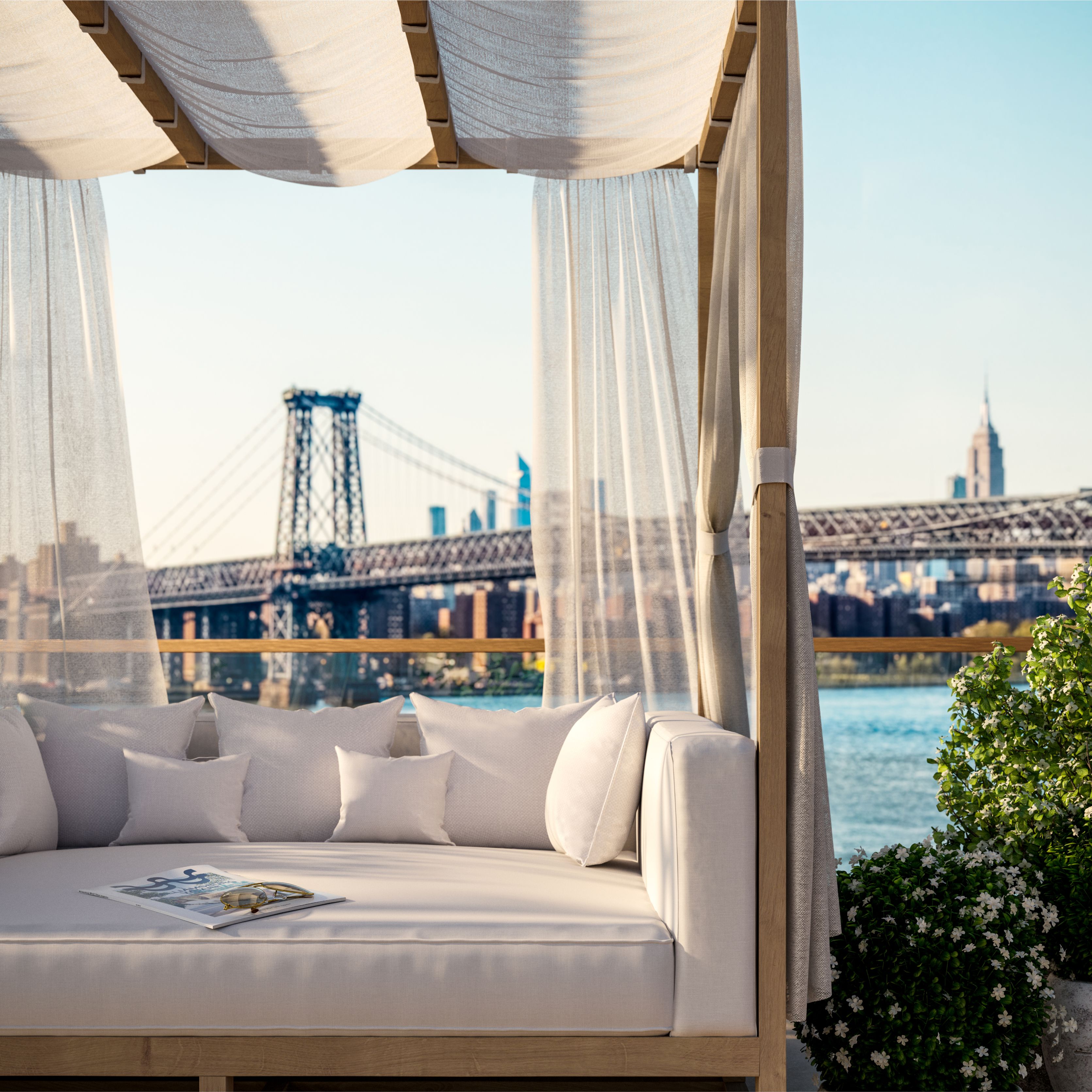 Daybed cabanas on the rooftop pool deck at One Williamsburg Wharf, with magnificent views of the East River and Manhattan skyline.