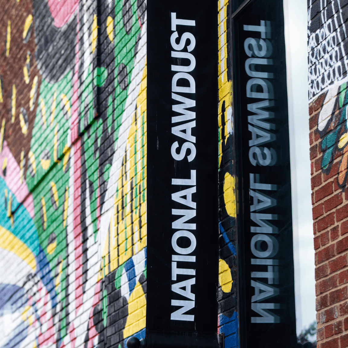 National Sawdust sign on graffiti wall - Culture in Williamsburg, Brooklyn