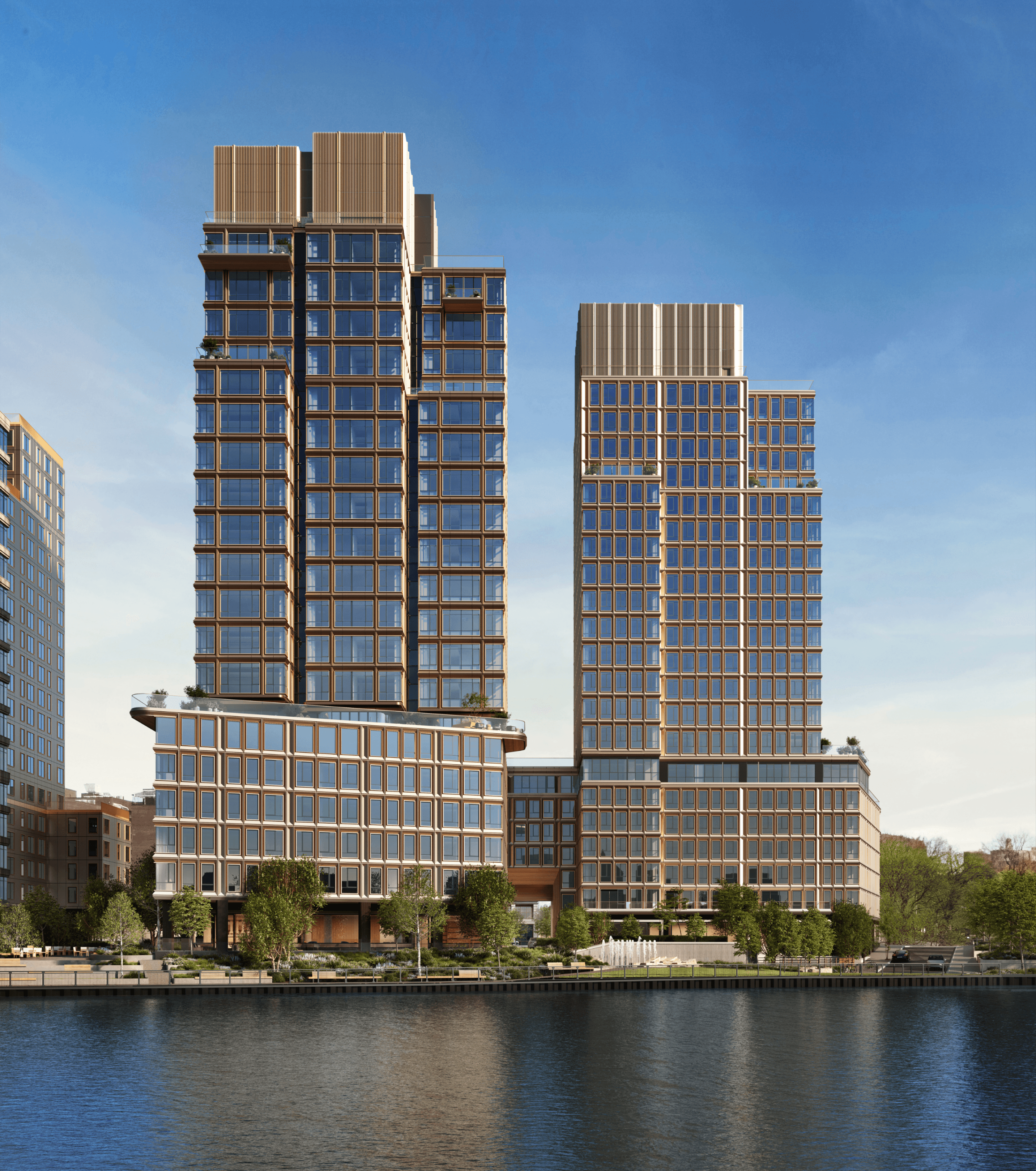 Williamsburg Wharf, modern architecture residential towers with green spaces, viewed from the East River in Brooklyn, NY.