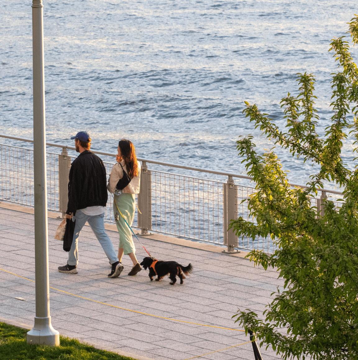 Couple walking dog - waterfront green spaces in Williamsburg, Brooklyn