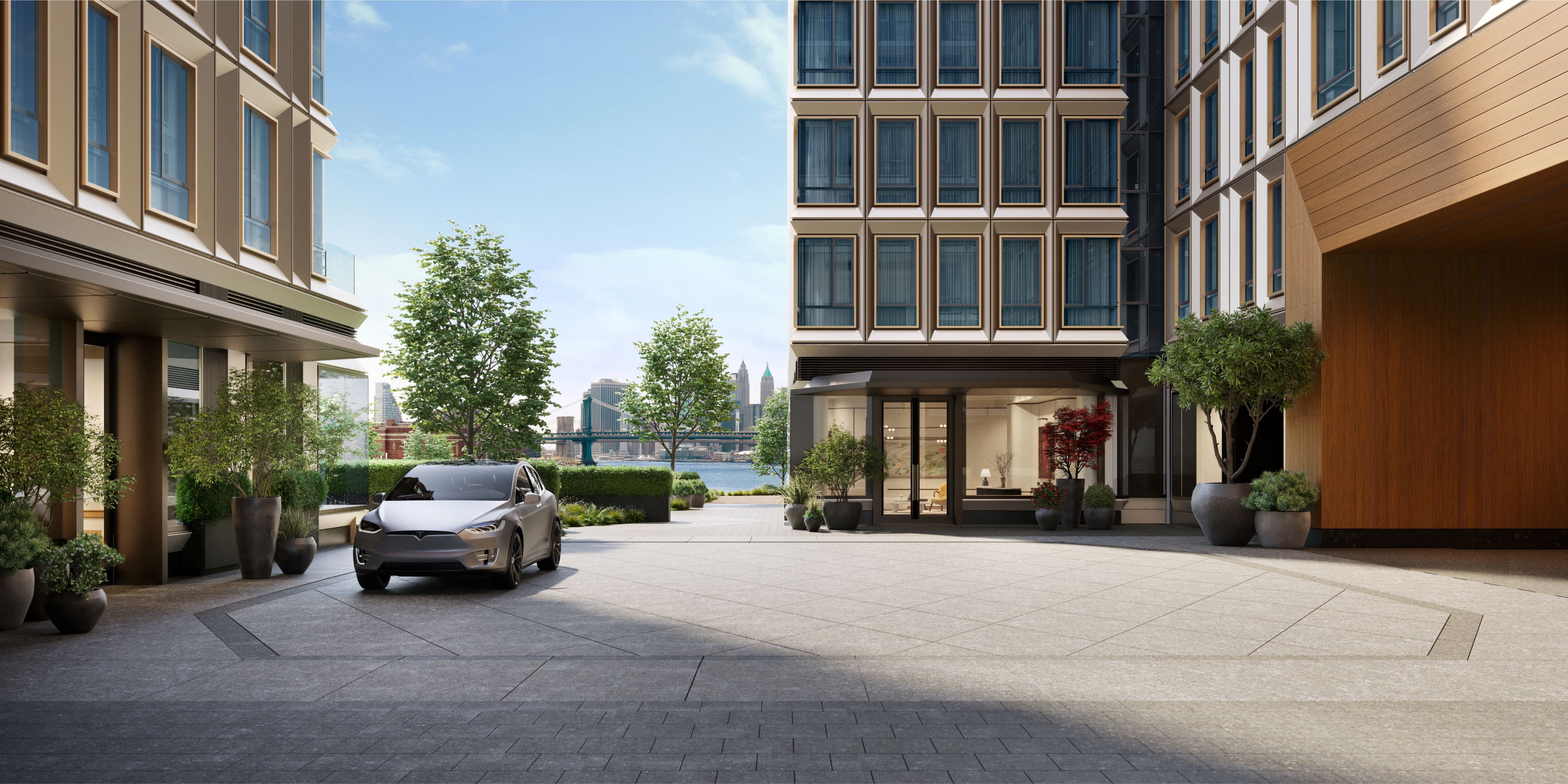 Landscaped motor court at One Williamsburg Wharf, offering new condos in Williamsburg, Brooklyn with modern architecture and East River views.