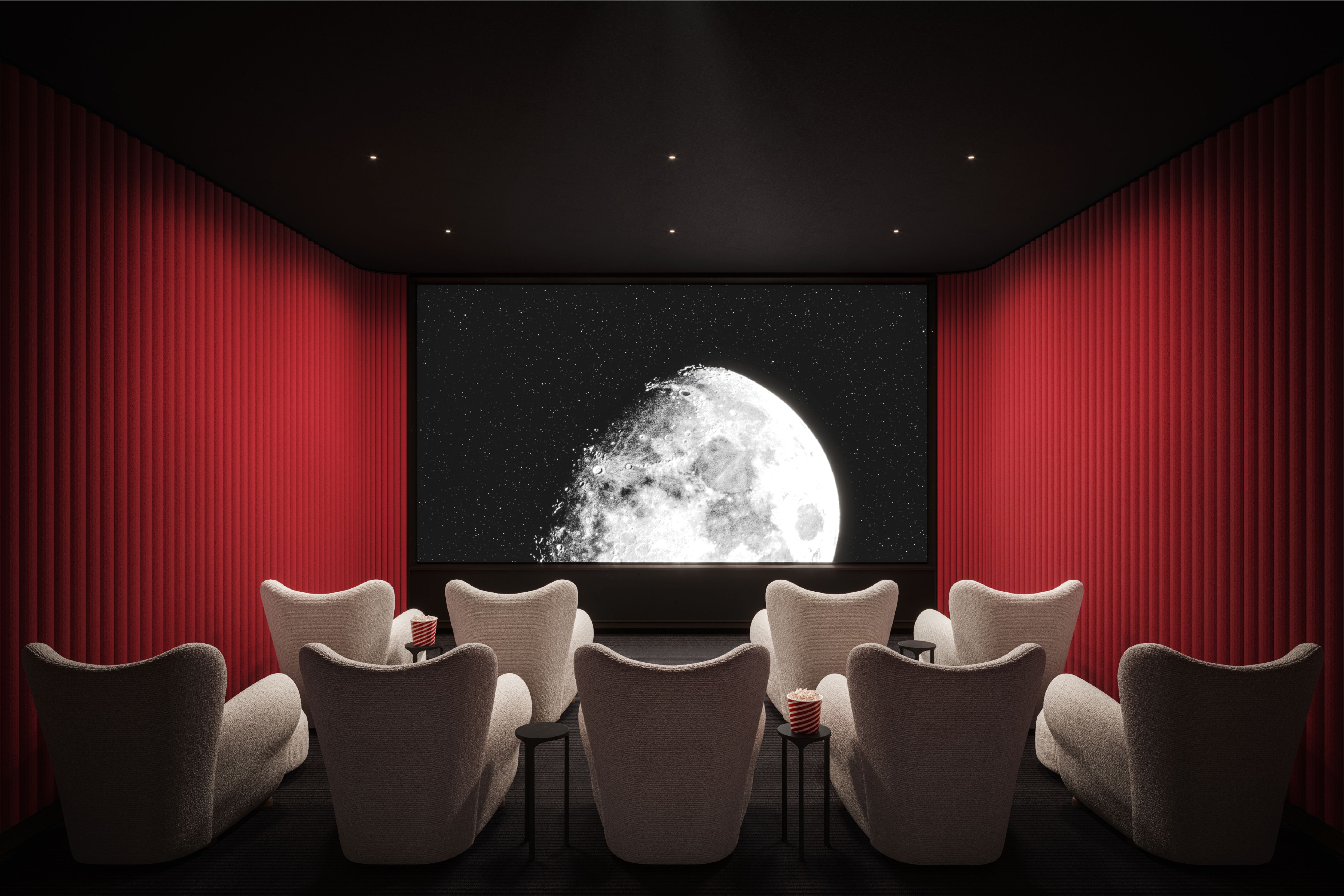 Private movie room at One Williamsburg Wharf with plush seating and a large screen.